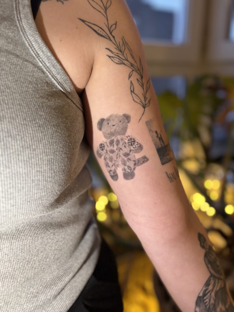  teddy bear tattooed inside of the upper arm, dot work, healed tattoo