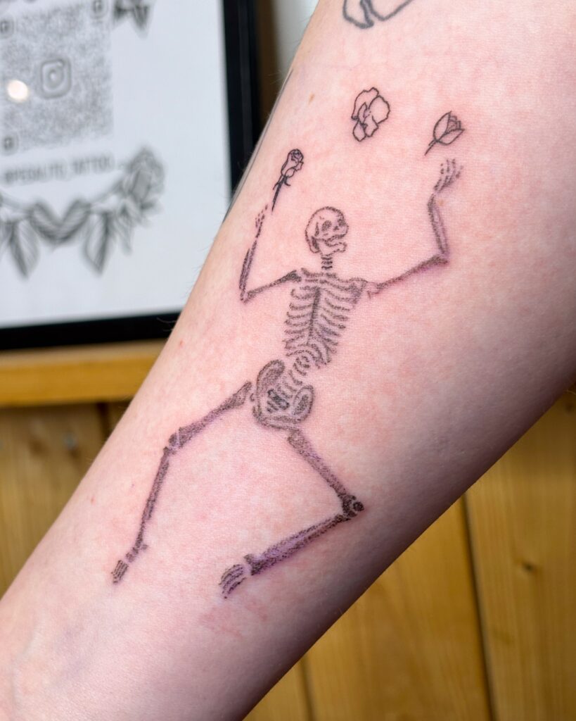 Image from tattoo gallery of odds tattoo, skeleton dancing and jingling with flowers, whip shading